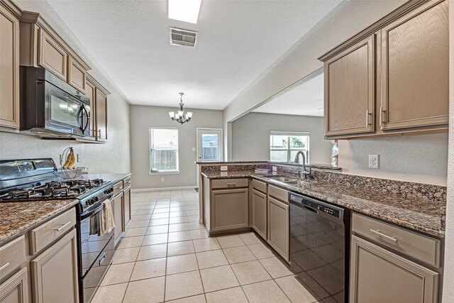 9807 Opal Rock Dr, Rosharon, TX 77583 - kitchen with black appliances, a sink, a peninsula, a chandelier, and dark stone counters