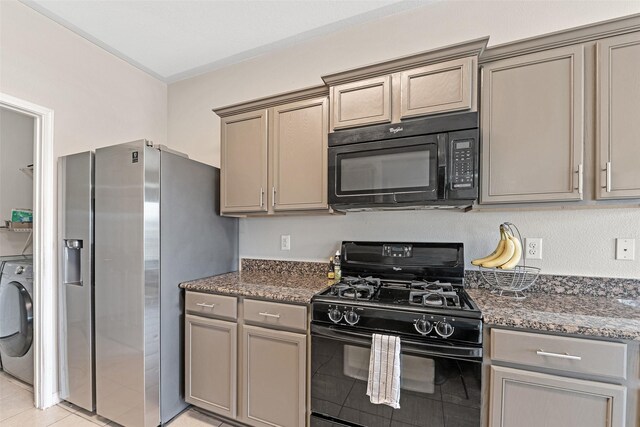9807 Opal Rock Dr, Rosharon, TX 77583 - kitchen with black appliances, washer / dryer, dark stone countertops, and gray cabinets