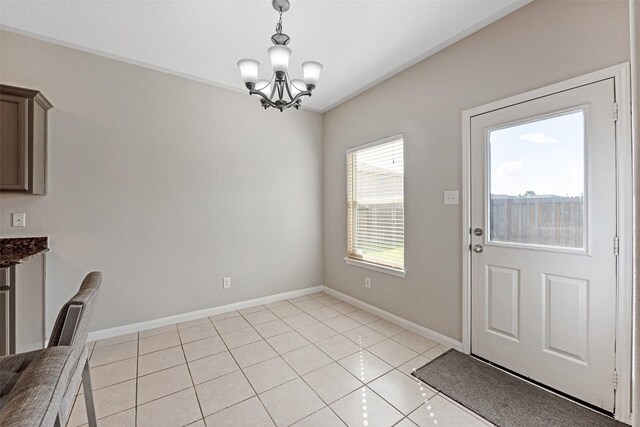 9807 Opal Rock Dr, Rosharon, TX 77583 - unfurnished dining area with a chandelier, light tile patterned floors, and baseboards