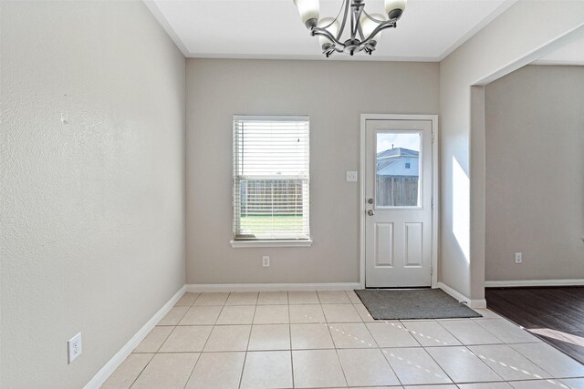 9807 Opal Rock Dr, Rosharon, TX 77583 - foyer with a chandelier, light tile patterned floors, and baseboards
