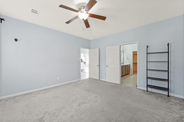 9807 Opal Rock Dr, Rosharon, TX 77583 - unfurnished bedroom featuring light colored carpet, baseboards, ensuite bath, and a ceiling fan
