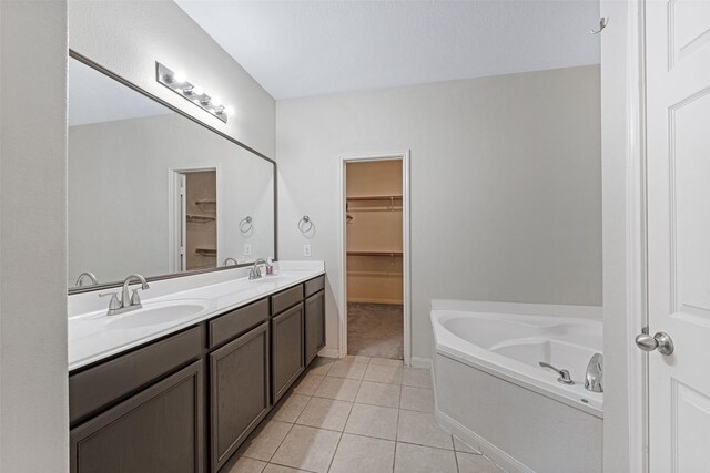 9807 Opal Rock Dr, Rosharon, TX 77583 - bathroom with a spacious closet, tile patterned flooring, a bath, and double vanity