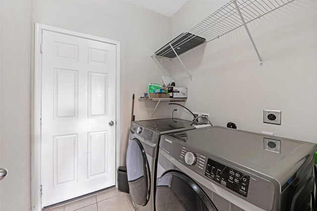 9807 Opal Rock Dr, Rosharon, TX 77583 - laundry room featuring washer and clothes dryer and light tile patterned floors
