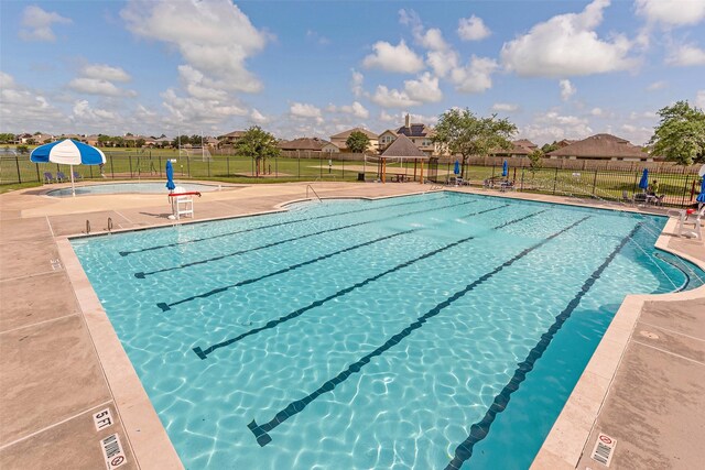 9807 Opal Rock Dr, Rosharon, TX 77583 - community pool featuring a patio