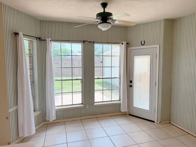 11442 Galbreath Dr, Houston, TX 77066 - doorway featuring a textured ceiling, a ceiling fan, healthy amount of natural light, tile patterned floors, and wallpapered walls