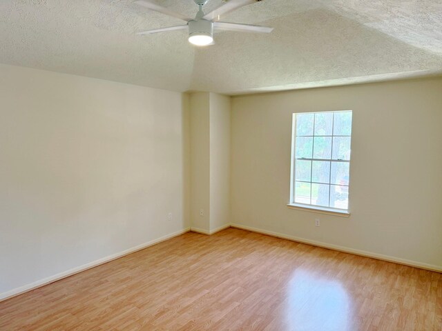 11442 Galbreath Dr, Houston, TX 77066 - unfurnished room featuring light wood-style flooring, a textured ceiling, a ceiling fan, and baseboards