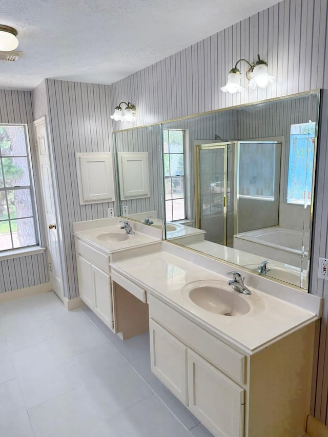 11442 Galbreath Dr, Houston, TX 77066 - bathroom with wallpapered walls, vanity, a stall shower, healthy amount of natural light, and a textured ceiling