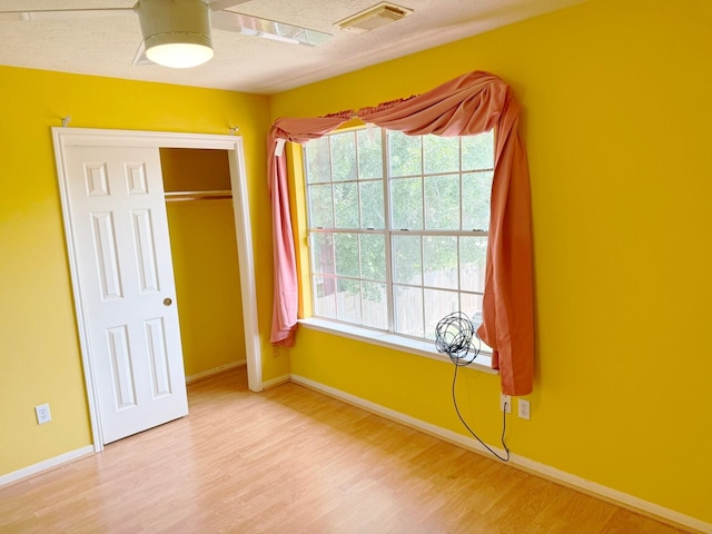 11442 Galbreath Dr, Houston, TX 77066 - unfurnished bedroom with wood finished floors, baseboards, a closet, and ceiling fan