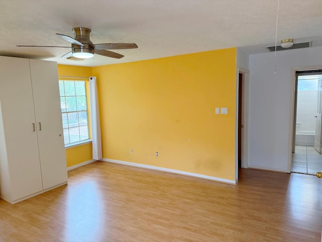 11442 Galbreath Dr, Houston, TX 77066 - spare room featuring light wood finished floors, plenty of natural light, a ceiling fan, and baseboards