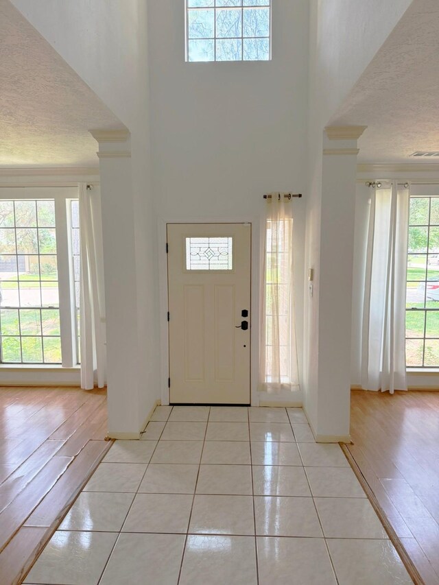 11442 Galbreath Dr, Houston, TX 77066 - foyer entrance featuring ornamental molding, a towering ceiling, baseboards, and light tile patterned floors