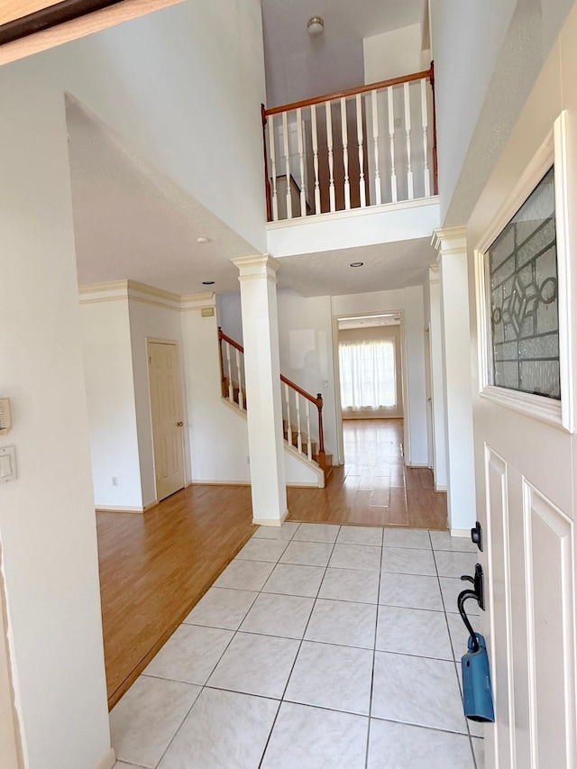 11442 Galbreath Dr, Houston, TX 77066 - foyer with tile patterned flooring, stairway, a towering ceiling, and baseboards