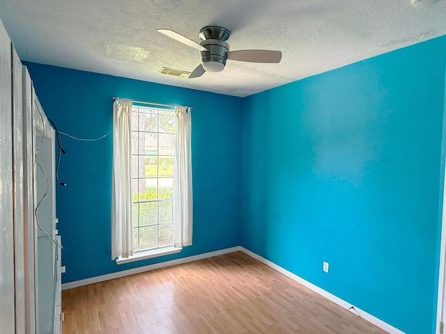 11442 Galbreath Dr, Houston, TX 77066 - empty room with a textured ceiling, a ceiling fan, wood finished floors, and baseboards