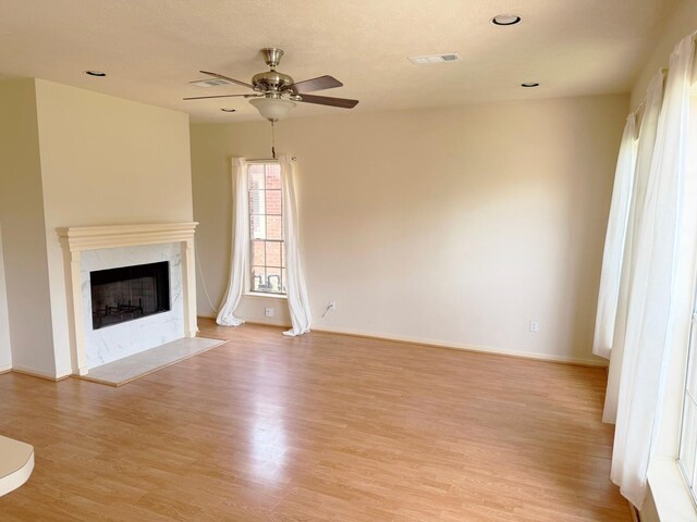 11442 Galbreath Dr, Houston, TX 77066 - unfurnished living room with a ceiling fan, light wood-style floors, a fireplace, baseboards, and recessed lighting