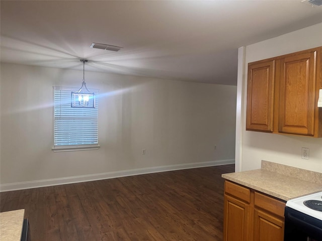 1412 Park Ln, Kilgore, TX 75662 - kitchen with brown cabinets, dark wood-style floors, light countertops, and baseboards