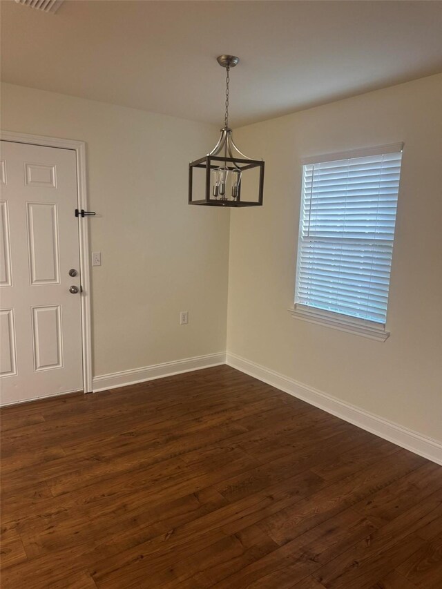 1412 Park Ln, Kilgore, TX 75662 - unfurnished dining area with baseboards, dark wood finished floors, and a chandelier