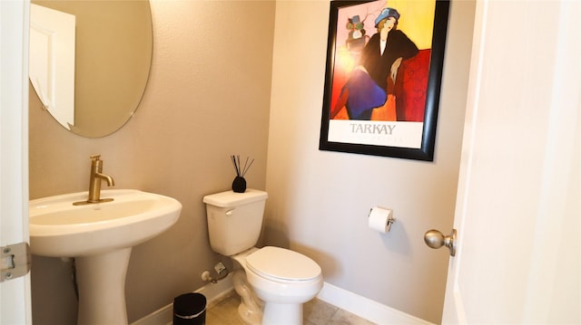 6005 Diamond Sky Ln, Houston, TX 77048 - bathroom with toilet, tile patterned floors, baseboards, and a sink