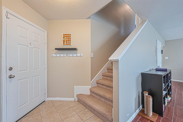 6623 Haven Forest Ln, Richmond, TX 77469 - entrance foyer featuring a textured ceiling, stairway, and baseboards