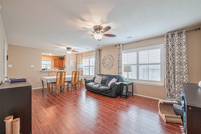 6623 Haven Forest Ln, Richmond, TX 77469 - living room with a ceiling fan, wood finished floors, baseboards, and a textured ceiling