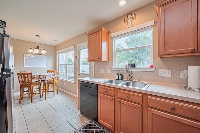 6623 Haven Forest Ln, Richmond, TX 77469 - kitchen with black dishwasher, a sink, freestanding refrigerator, baseboards, and plenty of natural light
