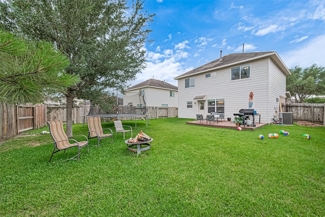 6623 Haven Forest Ln, Richmond, TX 77469 - rear view of property featuring cooling unit, a trampoline, and a fire pit