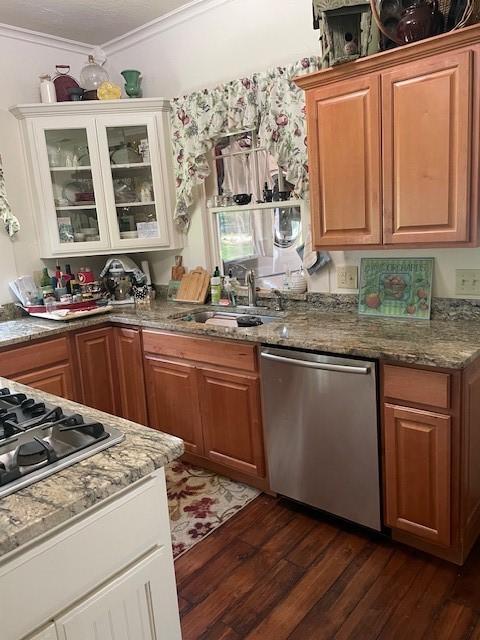 2114 E Lufkin Ave, Lufkin, TX 75901 - kitchen with appliances with stainless steel finishes, ornamental molding, dark wood-style floors, a sink, and glass insert cabinets