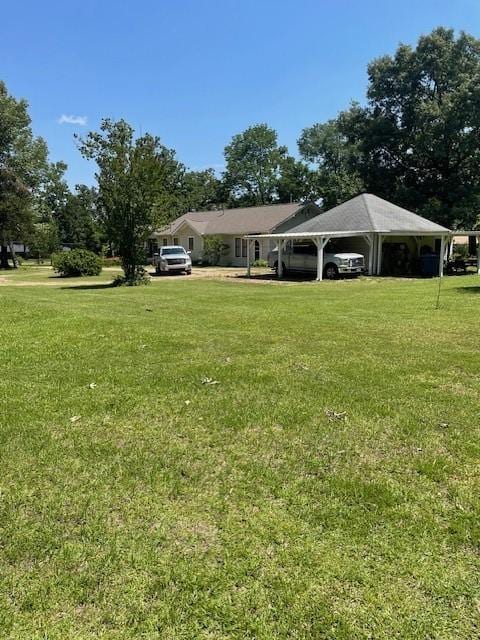 2114 E Lufkin Ave, Lufkin, TX 75901 - view of grassy yard featuring a detached carport