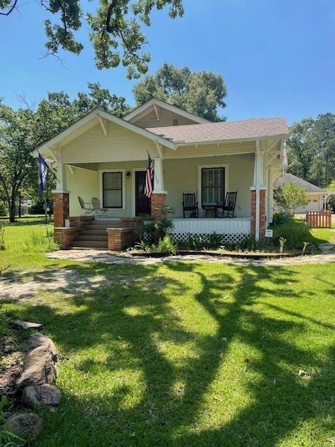 2114 E Lufkin Ave, Lufkin, TX 75901 - view of front of property featuring covered porch, a front yard, and brick siding