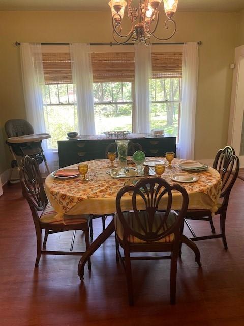 2114 E Lufkin Ave, Lufkin, TX 75901 - dining space featuring a chandelier, wood finished floors, and baseboards