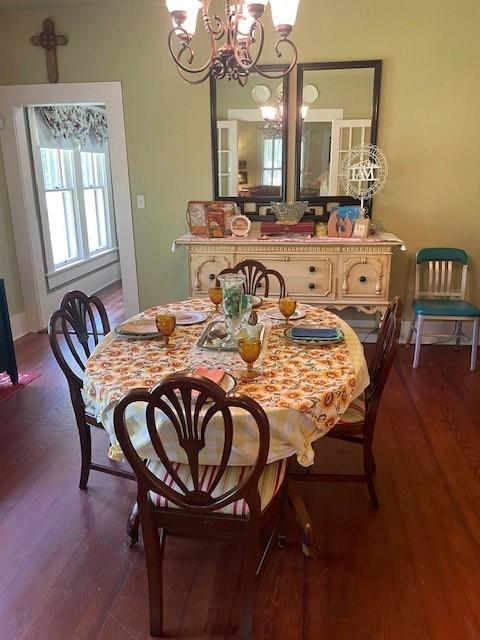 2114 E Lufkin Ave, Lufkin, TX 75901 - dining space featuring a chandelier, dark wood-style floors, and baseboards