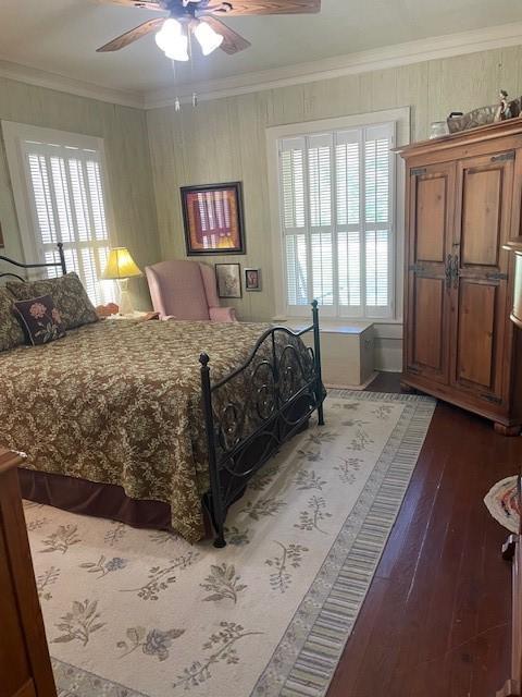 2114 E Lufkin Ave, Lufkin, TX 75901 - bedroom with ornamental molding, multiple windows, wood finished floors, and ceiling fan
