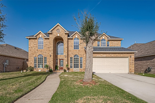 2213 Jernigan Frd, Dickinson, TX 77539 - traditional-style home featuring concrete driveway, brick siding, a front yard, and a garage