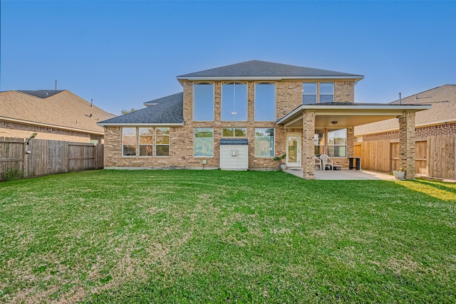 2213 Jernigan Frd, Dickinson, TX 77539 - rear view of property with a patio, brick siding, and a shingled roof