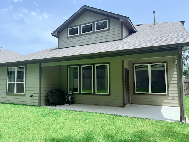10023 Angelina Woods Ln, Conroe, TX 77384 - rear view of property featuring roof with shingles, a patio area, and a yard