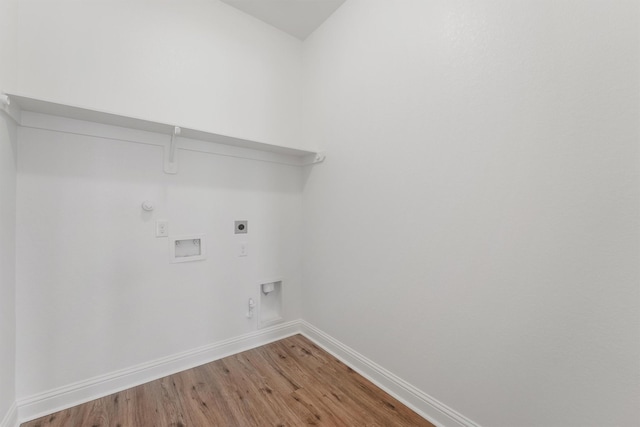 10091 Black Maple Dr, Conroe, TX 77385 - laundry area featuring gas dryer hookup, electric dryer hookup, baseboards, light wood-type flooring, and washer hookup