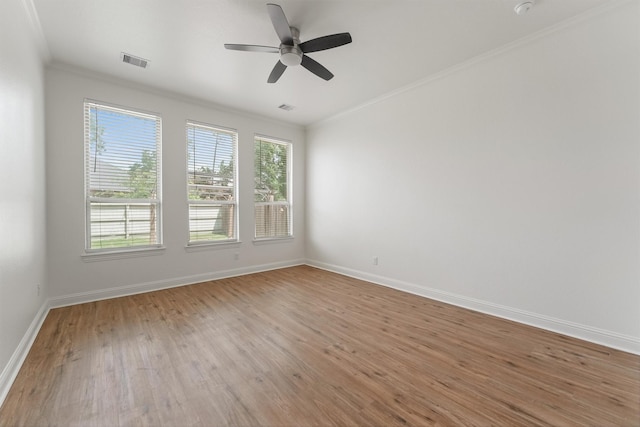 10091 Black Maple Dr, Conroe, TX 77385 - empty room with ornamental molding, a ceiling fan, baseboards, and wood finished floors