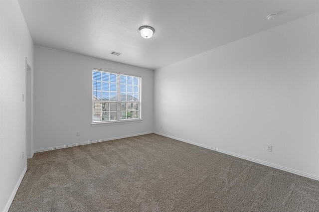 10091 Black Maple Dr, Conroe, TX 77385 - spare room featuring carpet and baseboards