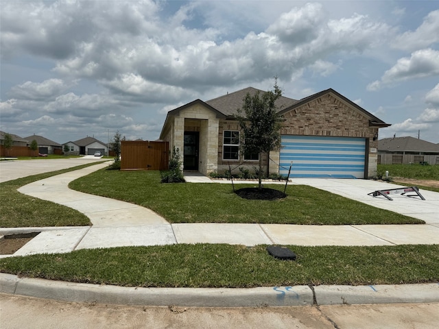 1203 Wildflower Way Dr, Beasley, TX 77417 - single story home with a garage, a front lawn, stone siding, and driveway