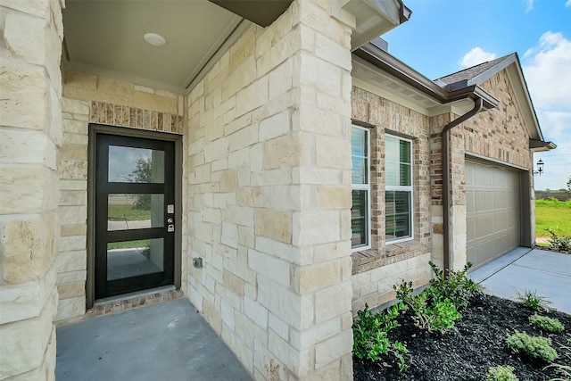 1203 Wildflower Way Dr, Beasley, TX 77417 - entrance to property with a garage, concrete driveway, and stone siding