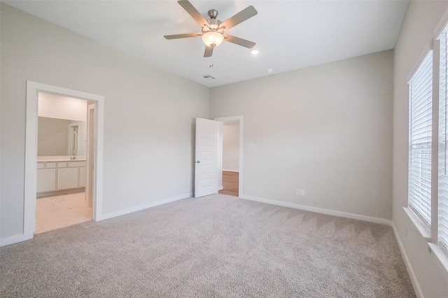1203 Wildflower Way Dr, Beasley, TX 77417 - unfurnished bedroom featuring carpet floors, ensuite bathroom, and ceiling fan