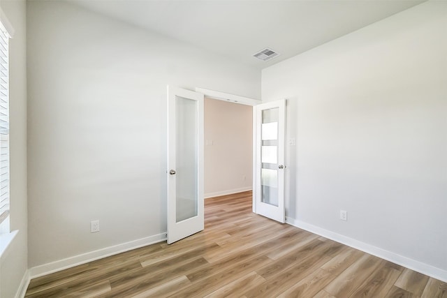 1203 Wildflower Way Dr, Beasley, TX 77417 - spare room with french doors and light wood-style flooring