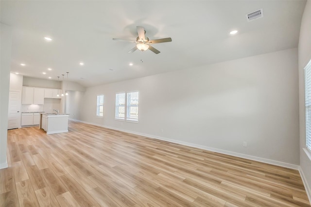 1203 Wildflower Way Dr, Beasley, TX 77417 - unfurnished living room featuring light wood finished floors, a ceiling fan, and recessed lighting