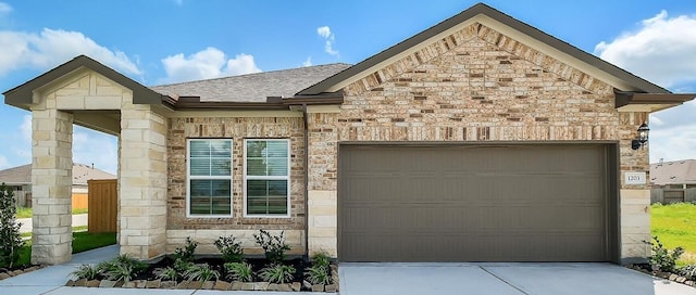 1203 Wildflower Way Dr, Beasley, TX 77417 - view of front facade featuring an attached garage, driveway, and stone siding