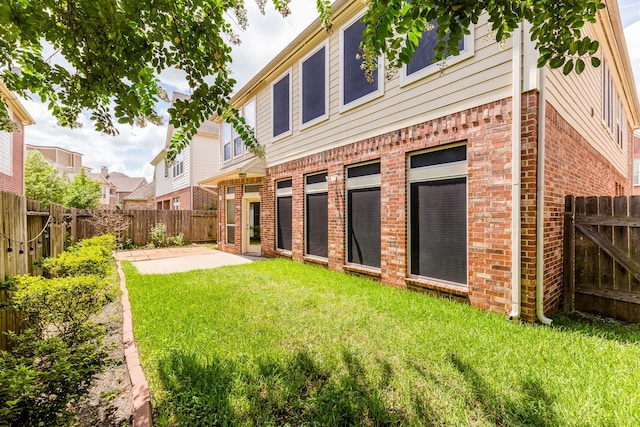 3531 Urban Woods Trl, Houston, TX 77008 - rear view of house with brick siding, a patio area, and a fenced backyard