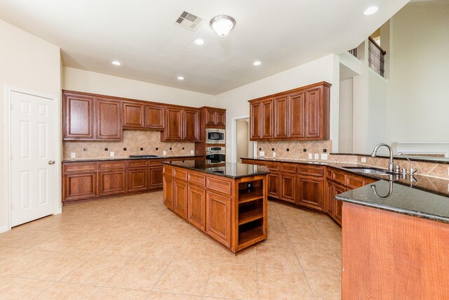 3531 Urban Woods Trl, Houston, TX 77008 - kitchen with appliances with stainless steel finishes, decorative backsplash, dark stone counters, light tile patterned floors, and recessed lighting