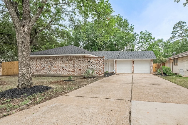 9003 Chateau Forest Dr, Houston, TX 77088 - view of front of property featuring brick siding, an attached garage, roof with shingles, and concrete driveway