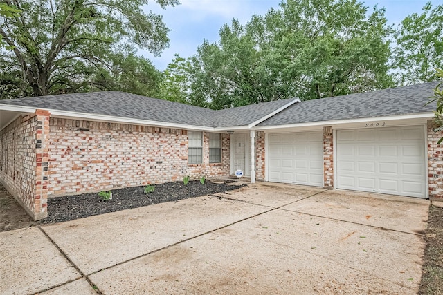 9003 Chateau Forest Dr, Houston, TX 77088 - view of front of house featuring a garage, a shingled roof, concrete driveway, and brick siding