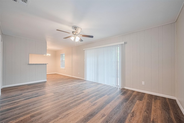 9003 Chateau Forest Dr, Houston, TX 77088 - unfurnished living room with ceiling fan, dark wood-style floors, and baseboards