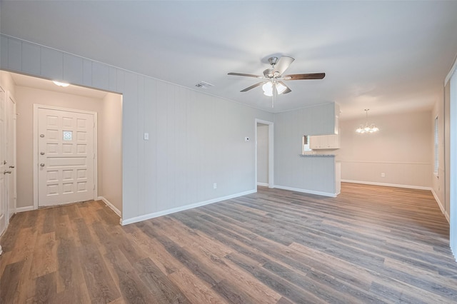 9003 Chateau Forest Dr, Houston, TX 77088 - unfurnished living room featuring ceiling fan, a chandelier, wood finished floors, and baseboards