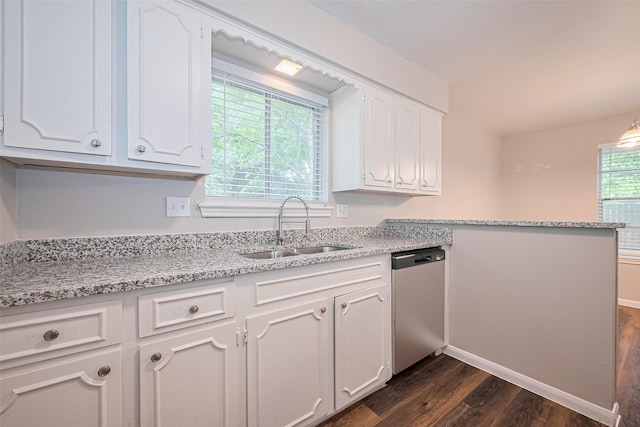9003 Chateau Forest Dr, Houston, TX 77088 - kitchen featuring stainless steel dishwasher, a sink, dark wood-style floors, white cabinets, and a peninsula