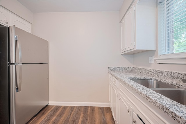 9003 Chateau Forest Dr, Houston, TX 77088 - kitchen featuring freestanding refrigerator, dark wood-style flooring, white cabinetry, and baseboards